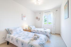 a bedroom with two beds and a window at Cala Egos Villa - S'Estel in Cala d´Or +19 photos