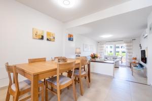 a kitchen and dining room with a wooden table and chairs at Cala Egos Villa - S'Estel in Cala d´Or