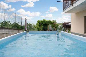 a swimming pool with a water slide in a house at Casa Pianezzo Dogliani in Dogliani