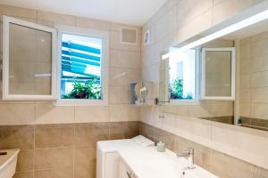 a bathroom with a sink and a mirror at Gure Xokoa in Urrugne +15 photos
