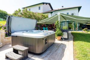a hot tub in the backyard of a house at Gure Xokoa in Urrugne