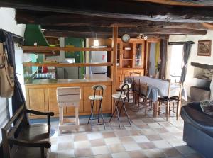 a kitchen and dining room with a table and chairs at Gîte De Ty Louti in Plouyé