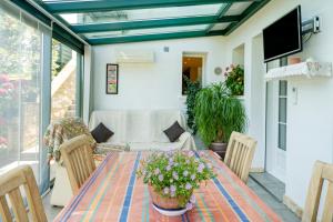 a patio with a table and chairs and a couch at Gure Xokoa in Urrugne