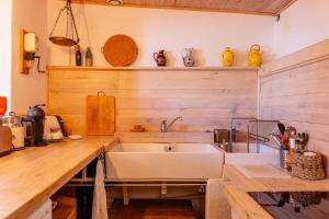 a kitchen with a large sink and wooden counters at Cocooning in Puimoisson +26 photos