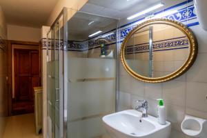 a bathroom with a sink and a mirror at Residenza Palazzo Ghio in Scansano +20 photos