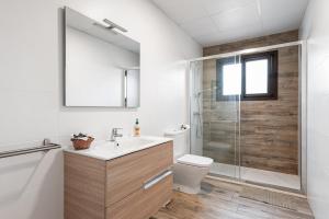 a bathroom with a shower and a sink and a toilet at Finca Llano de Fe in Málaga +23 photos