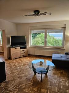 a living room with a couch and a glass table at Ferienoase Weitblick in Rinteln