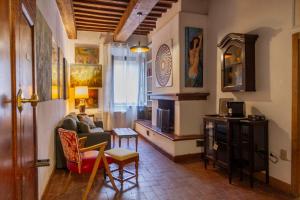 a living room with a couch and a table at Residenza Palazzo Ghio in Scansano