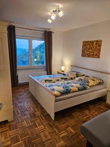 a bedroom with a bed and a large window at Ferienoase Weitblick in Rinteln