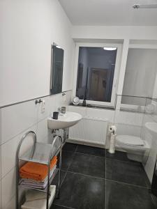 a white bathroom with a sink and a mirror at Ferienoase Weitblick in Rinteln +30 photos