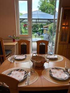a table with plates and napkins on top of it at Heiderast Wipperau in Oetzen