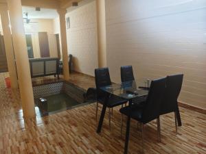 a conference room with a glass table and chairs at Quality Inn Resort in Varkala +17 photos