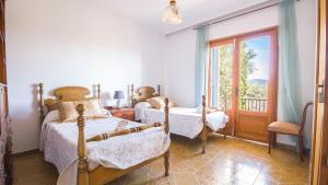 a bedroom with two beds and a balcony at Na Penyal Ref 246 in Cala Millor +18 photos