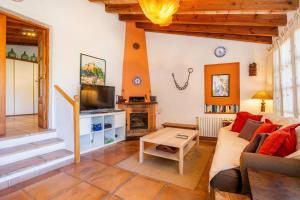 a living room with a couch and a tv at Tramuntana in Valldemossa