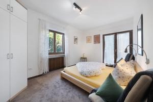 a bedroom with a bed and a large window at Katharina in Lana +10 photos