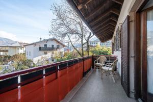 a balcony with two chairs and a table on it at Katharina in Lana