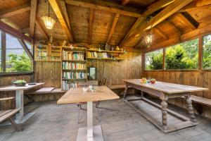 a room with wooden walls and tables and bookshelves at Katharina in Lana