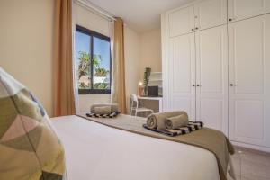 a bedroom with a bed with two towels on it at Oasis Duna _ Casa Martineli Pool in Corralejo +19 photos
