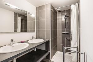 a bathroom with two sinks and a shower at Gîte De L'orchidée in Saint-Épain +31 photos