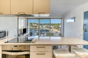 a kitchen with a table with a view of a living room at 1a Linea mar port Llafranch in Llafranc
