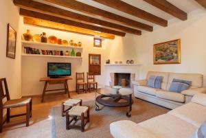 a living room with a couch and a table at Butxaco in Pollença