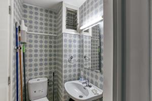 a small bathroom with a toilet and a sink at 1a Linea mar port Llafranch in Llafranc +22 photos
