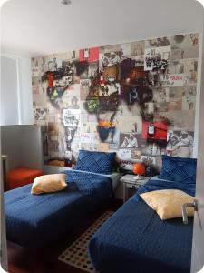 a bedroom with two beds and a wall with pictures at Design villa with sea views in San Pol de Mar +37 photos