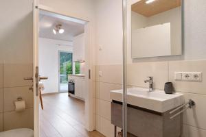 a bathroom with a sink and a mirror at Wanderlust in Todtnau +23 photos