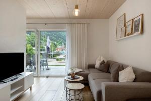 a living room with a couch and a tv at Wanderlust in Todtnau