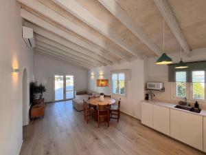 a kitchen and living room with a table and a couch at Casa Menorquina Son Moix in Ciutadella