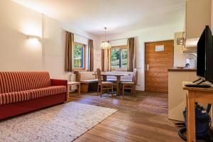 a living room with a couch and a table at Sabina Dolomites Piz in Alpe di Siusi