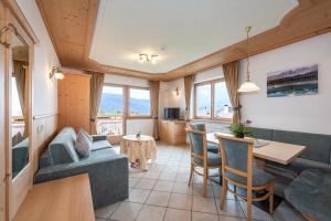 a living room with a couch and a table at Residence Diana Apartment 303 in Terento