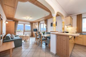a kitchen and living room with a table and chairs at Residence Diana Apartment 303 in Terento