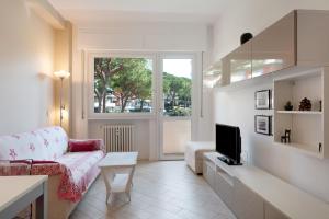 a living room with a couch and a tv at Solaria in Rapallo