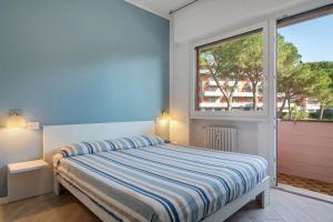 a bedroom with a bed and a large window at Solaria in Rapallo