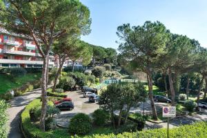 a street with cars parked in a parking lot at Solaria in Rapallo