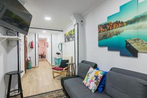 a living room with a couch and a tv at Apto Casco viejo Castro Urdiales in Castro-Urdiales