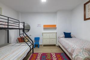 a bedroom with two bunk beds and a desk at Apto Casco viejo Castro Urdiales in Castro-Urdiales