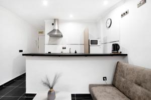 a living room with a couch and a kitchen at Estudio centro de Torremolinos in Torremolinos +14 photos
