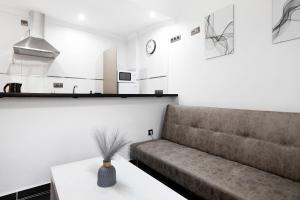 a living room with a couch and a table at Estudio centro de Torremolinos in Torremolinos