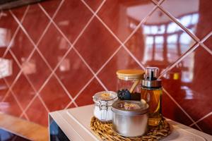 a tray with bottles and jars on top of a counter at Casa Florenta G2 in Cangas de Onís