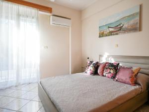 a bedroom with a bed and a painting on the wall at Villa Elysian in Antimácheia +18 photos