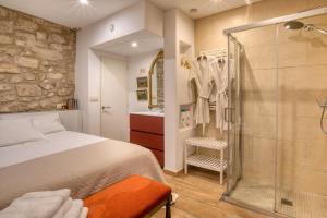 a bedroom with a bed and a glass shower at Old Side Girona one in Girona