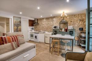 a kitchen and living room with a couch and a table at Old Side Girona one in Girona +13 photos