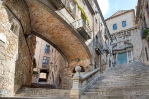 an archway in an old building with stairs at Old Side Girona one in Girona