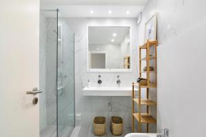 a bathroom with a sink and a glass shower at Apartamento Acácia in Vale do Lobo +20 photos