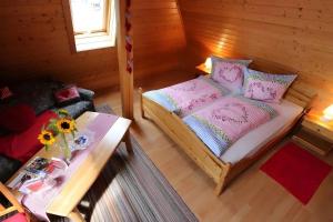 a small bedroom with a bed and a table at Wohnung im Gästehaus Waldhüsle in Friedenweiler