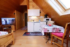 a kitchen with a table in a room at Wohnung im Gästehaus Waldhüsle in Friedenweiler