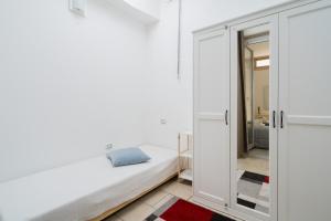a bedroom with a bed and a glass door at Villa I Gabbiani a Otranto in Otranto
