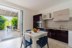 a kitchen with a table and chairs and a dining room at Villa I Gabbiani a Otranto in Otranto +21 photos